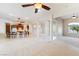 Large living area with open access to the kitchen and multiple ceiling fans at 2500 S Zephyr Ave, Pahrump, NV 89048