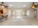 Open-concept living space with tile flooring, columns, ceiling fans and a view of the foyer at 2500 S Zephyr Ave, Pahrump, NV 89048