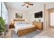 Stylishly furnished main bedroom with a ceiling fan, TV, and sliding door closet at 2500 S Zephyr Ave, Pahrump, NV 89048