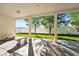 Covered patio with white pillars, tile floors, and artificial grass in the backyard at 2500 S Zephyr Ave, Pahrump, NV 89048