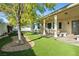 Covered patio featuring stone benches and meticulous landscaping with artificial grass at 2500 S Zephyr Ave, Pahrump, NV 89048