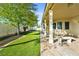 View of the patio and manicured yard featuring a stone border and artificial grass at 2500 S Zephyr Ave, Pahrump, NV 89048