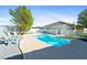 The backyard pool has mature trees, and seating, ideal for outdoor enjoyment at 2500 S Zephyr Ave, Pahrump, NV 89048