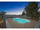 A fenced pool with an irregular shape offers relaxing evenings with mountain views at 2500 S Zephyr Ave, Pahrump, NV 89048