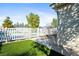 Fenced pool area features artificial grass and a view through to the pool area at 2500 S Zephyr Ave, Pahrump, NV 89048