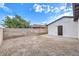 Backyard featuring a block wall, dirt, and a small patio at 2536 Herrod Dr, North Las Vegas, NV 89030
