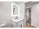 Bathroom featuring a modern sink and a backlit mirror at 2536 Herrod Dr, North Las Vegas, NV 89030