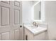 Bathroom boasts modern vanity with gold fixtures and backlit mirror at 2536 Herrod Dr, North Las Vegas, NV 89030