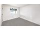 Bright bedroom with large window and neutral carpet flooring at 2536 Herrod Dr, North Las Vegas, NV 89030