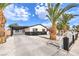 Charming single-story home featuring a covered carport, white fence, and well-maintained landscaping at 2536 Herrod Dr, North Las Vegas, NV 89030