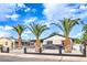 Single-story home with palm trees, white fence, carport, and fresh exterior paint at 2536 Herrod Dr, North Las Vegas, NV 89030