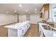 Modern kitchen boasts a huge island with barstool seating, stainless steel appliances, and lots of space at 2536 Herrod Dr, North Las Vegas, NV 89030