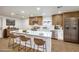 Modern kitchen boasts stainless steel appliances, an island with seating, and a bright, airy atmosphere at 2536 Herrod Dr, North Las Vegas, NV 89030