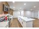 Modern kitchen and island boasts stone countertops, stainless appliances, lots of room, and access doors at 2536 Herrod Dr, North Las Vegas, NV 89030