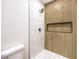 Modern walk-in shower features stylish wood accents, a rainfall shower head, and tiled flooring at 2536 Herrod Dr, North Las Vegas, NV 89030