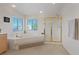 Bright bathroom featuring a soaking tub and glass-enclosed shower at 272 Violet Note St, Henderson, NV 89074