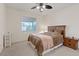 Cozy bedroom with neutral tones, a ceiling fan, and a comfortable bed at 272 Violet Note St, Henderson, NV 89074