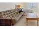 Well-lit bedroom featuring a full-sized bed and a cozy seating area at 272 Violet Note St, Henderson, NV 89074