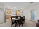Bright dining area open to the kitchen features a glass table with seating for four at 272 Violet Note St, Henderson, NV 89074