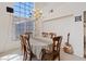 Formal dining area with chandelier and large windows providing natural light and style at 272 Violet Note St, Henderson, NV 89074