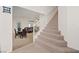 Hallway featuring carpeted stairs, dining area, and access to the living room at 272 Violet Note St, Henderson, NV 89074
