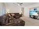 Inviting living room features comfortable leather seating and a modern entertainment center at 272 Violet Note St, Henderson, NV 89074