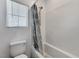 Bathroom with a tub and shower featuring white tile and a window for natural light at 2796 Sipe Springs St, Las Vegas, NV 89142