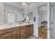 Bathroom with a double sink vanity, large mirror, and view of the music room at 2796 Sipe Springs St, Las Vegas, NV 89142