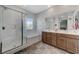 Bathroom featuring tiled floors, double vanity sinks, and a glass shower at 2796 Sipe Springs St, Las Vegas, NV 89142