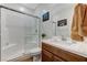 Bathroom featuring a glass-enclosed shower, vanity with sink, and neutral decor, creating a soothing ambiance at 2796 Sipe Springs St, Las Vegas, NV 89142
