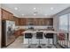 Modern kitchen boasting granite countertops, stainless steel appliances, and a convenient breakfast bar at 2796 Sipe Springs St, Las Vegas, NV 89142