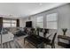 Open living space featuring wood-look flooring, dining area and comfortable seating near large windows at 2796 Sipe Springs St, Las Vegas, NV 89142