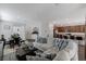 Open-concept living room with a comfortable gray sofa, dining area, and kitchen with a breakfast bar at 2796 Sipe Springs St, Las Vegas, NV 89142