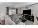 Living room features sectional couch with a large flat screen tv at 2796 Sipe Springs St, Las Vegas, NV 89142