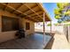 Covered back patio with grill and bucket overlooking gravel-filled backyard at 2805 Rungsted St, Las Vegas, NV 89142
