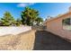 Fenced backyard space filled with decorative gravel next to stucco home at 2805 Rungsted St, Las Vegas, NV 89142