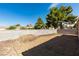 Fenced backyard space filled with decorative gravel and scattered trees at 2805 Rungsted St, Las Vegas, NV 89142