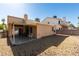 A patio is connected to a gravel backyard with a chair and grill at 2805 Rungsted St, Las Vegas, NV 89142
