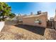 Fenced backyard space filled with decorative gravel next to stucco home at 2805 Rungsted St, Las Vegas, NV 89142