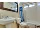 Clean bathroom features a sink, toilet and bathtub/shower combination with white tile at 2805 Rungsted St, Las Vegas, NV 89142