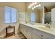 Well-lit bathroom with double sinks, large mirrors, and stylish tile flooring at 2805 Rungsted St, Las Vegas, NV 89142