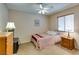 Cozy bedroom with neutral tones, ceiling fan and a window with natural light at 2805 Rungsted St, Las Vegas, NV 89142