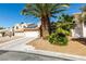 Front exterior with palm tree and drought tolerant landscaping in front yard at 2805 Rungsted St, Las Vegas, NV 89142