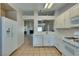 Bright kitchen boasts white cabinetry and appliances, open to the living area at 2805 Rungsted St, Las Vegas, NV 89142