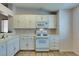 Practical kitchen has white appliances, ample storage, and tile backsplash at 2805 Rungsted St, Las Vegas, NV 89142