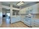 Well-lit kitchen features white cabinets, an oven and access to the living room at 2805 Rungsted St, Las Vegas, NV 89142
