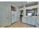 Functional kitchen layout with white appliances and cabinetry, open to living area at 2805 Rungsted St, Las Vegas, NV 89142