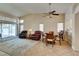 Open-concept living area features a dining area, tile flooring, and access to backyard via glass sliding door at 2805 Rungsted St, Las Vegas, NV 89142