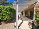 Backyard boasts a large covered patio with a pergola and lush landscaping at 2809 Winslow Springs Dr, Henderson, NV 89052