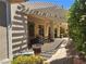 Backyard featuring covered patio, pergola, tasteful landscaping, with an outdoor BBQ area at 2809 Winslow Springs Dr, Henderson, NV 89052